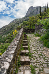 Fototapeta na wymiar Steep pathway to fortress and church above old town Kotor in Montenegro