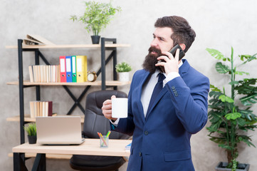 Coffee is pledge of successful negotiations. Caffeine addicted. Man bearded businessman hold cup...