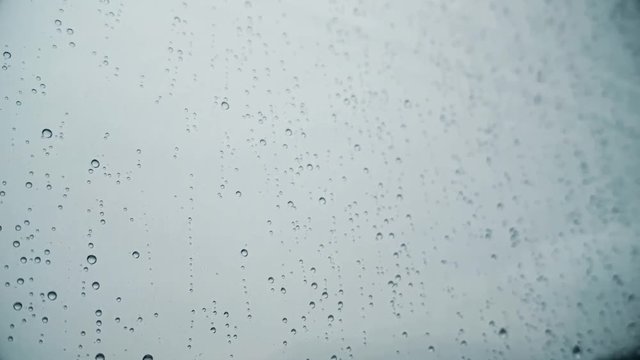 Close up HD footage of some raindrops on a window.