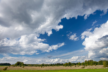 landscape of russian field with blue sky and beautiful clouds