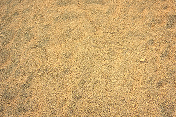 Fototapeta na wymiar Fine gravel background in beige color tone, top view. Shadows of the sunset light on the surface