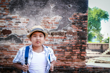 Asian boy visiting ancient ruins of ancient Ayutthaya, Thailand