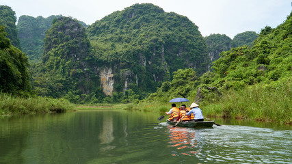 Fototapeta na wymiar Boat tour, beautiful landscape with karst mountains and river in Trang An, Ninh Binh, Tam Coc, Vietnam. 