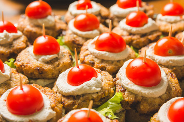 Tasty vegan burger sandwiches with cherry tomato on top