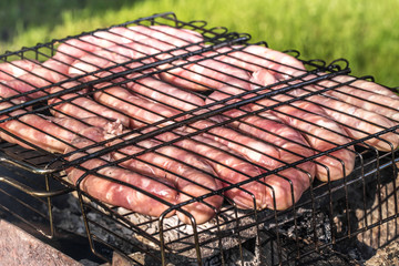 Friends making barbecue and having lunch in the nature.