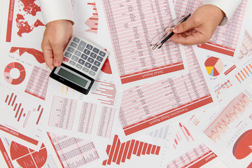 Obraz premium Flat top view of businessman working and calculating finance, reads and writes reports. Business financial accounting concept.