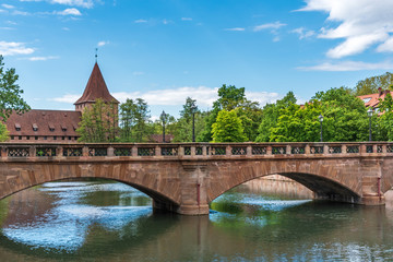 Fototapeta na wymiar Old stone bridge, in the summer under the blue sky in a European city
