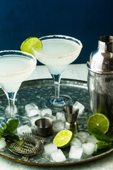classic margarita cocktail on the table with bar accessories.