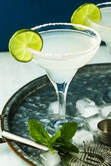 classic margarita cocktail on the table with bar accessories.