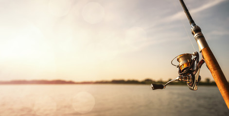 Close up of a fishing rod during the sunset with copy space