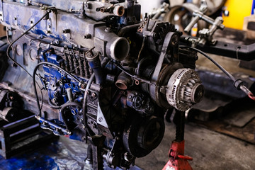 Fototapeta na wymiar Mechanic opened the locking valve mechanism. Disassemble engine block vehicle. Old motor capital repair. Car service concept