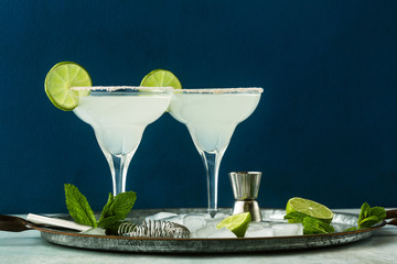 classic margarita cocktail on the table with bar accessories.