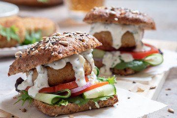 Gourmet Fish seafood burger with mayo and fresh vegetables