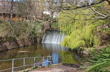 The weir on the river Sid in Sidmouth, Devon in the parkland area known as The Byes
