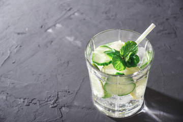 Detox cocktail with water, cucumber, lemon and mint with copy space