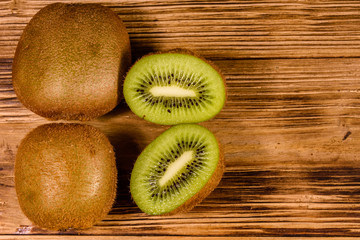 Ripe kiwi fruits on a wooden table. Top view