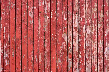 Wood planks, planks painted in red. The paint was peeling. Vertically.  Four of the cap of the nail