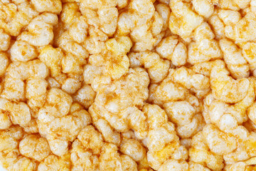 Caramelized corn cakes. Puffed whole grain crispbread isolated on white background. Close-up.