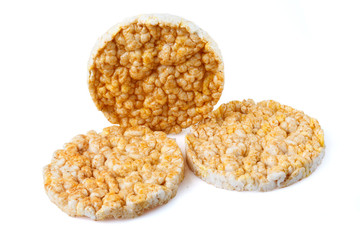 Caramelized corn cakes. Puffed whole grain crispbread isolated on white background. Close-up.