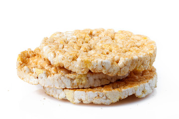 Caramelized corn cakes. Puffed whole grain crispbread isolated on white background. Close-up.