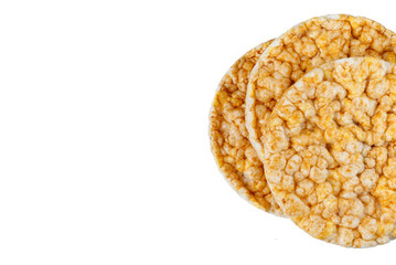 Caramelized corn cakes. Puffed whole grain crispbread isolated on white background. Close-up.