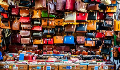 Foto op Plexiglas Colorful leather purses, handbags, wallets and handbags are displayed by street vendors at an outdoor Market, in Florence, Italy. © David A Litman