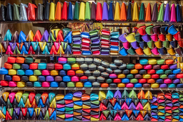 Fototapeta na wymiar Colorful leather purses, handbags, wallets and handbags are displayed by street vendors at an outdoor Market, in Florence, Italy.