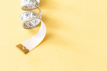 Tape-measure isolated on yellow, sewing tools elements for paper pattern construction and clothes...