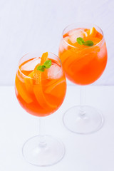Aperol Spritz cocktail with mint leaves on a white background. Italian cocktail aperol spritz on white. Isolated