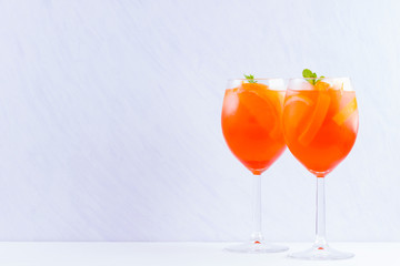 Aperol Spritz cocktail with mint leaves on a white background. Italian cocktail aperol spritz on...