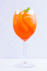 Aperol Spritz cocktail with mint leaves on a white background. Italian cocktail aperol spritz on white. Isolated