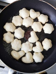 Frying doughnuts in the pan - homemade dessert  - cooking  at home
