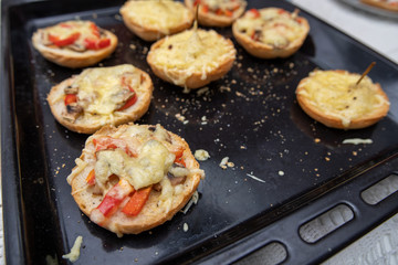 Tasty casserole with cheese on a baking tray from the oven. A fresh meal prepared in a home kitchen.