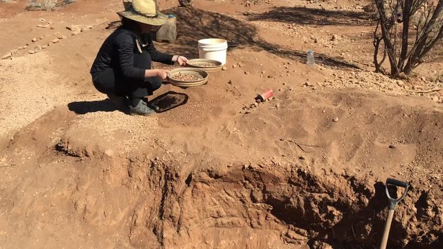 Australian woman fossicking (searching)  gem stones in the outback of the Northern Territory, Australia.
