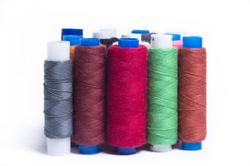 Spools of thread standing vertically on white background