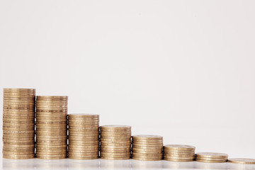 Coins in the form of a histogram on a white background. Concept of lending, savings, insurance.