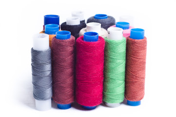 Spools of thread standing vertically on white background