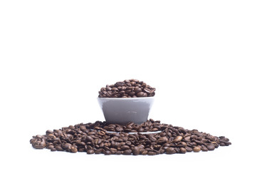 White cup with coffee beans on white background