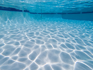 Underwater view of empty clean suburban swimming pool.