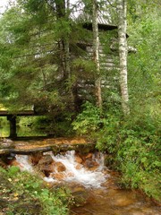 old chapel by a stream in the forest