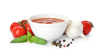 Composition with bowl of tomato sauce and vegetables isolated on white