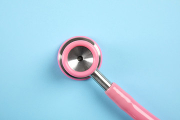 Stethoscope on color background, top view. Medical tool