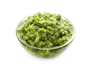 Bowl of tasty pesto sauce isolated on white