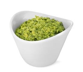 Bowl of tasty pesto sauce isolated on white