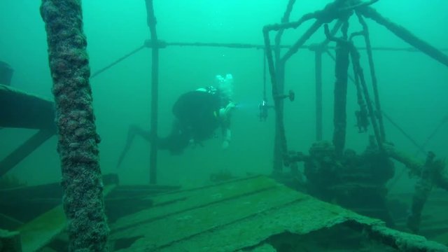 Scuba diver explores water check valve on goldrush paddlwheel AJ Goddard