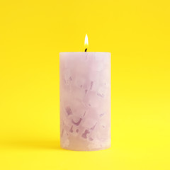Alight scented wax candle on color background