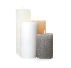 Many color wax candles on white background