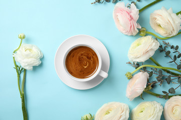 Flat lay composition with spring ranunculus flowers and cup of coffee on color background