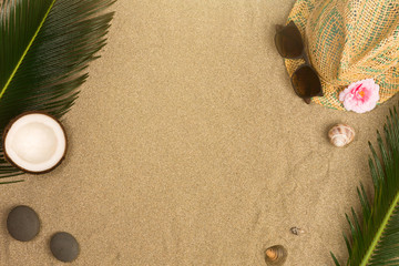 Fototapeta na wymiar Top view of palm leaves on beach sand background. Flat lay. Travel concept, empty space for text