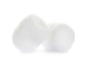 Balls of fluffy cotton on white background